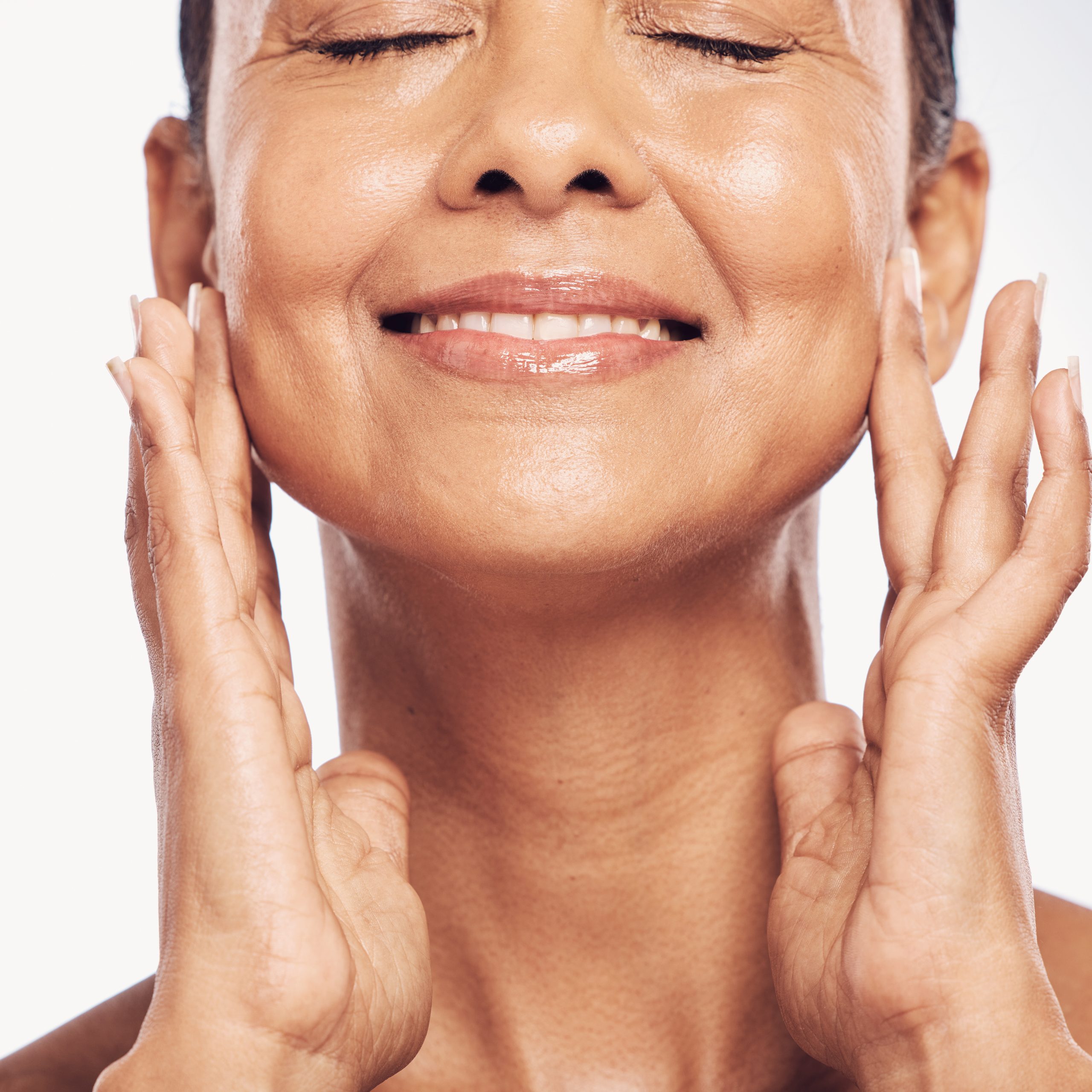 Closeup, cosmetics and mature woman with skincare, dermatology and self care against a studio background. Female, beauty and person with organic facial, face detox and treatment with grooming routine Closeup, cosmetics and mature woman with skincare, dermatology and self care against a studio background. Female, beauty and person with organic facial, face detox and treatment with grooming routine