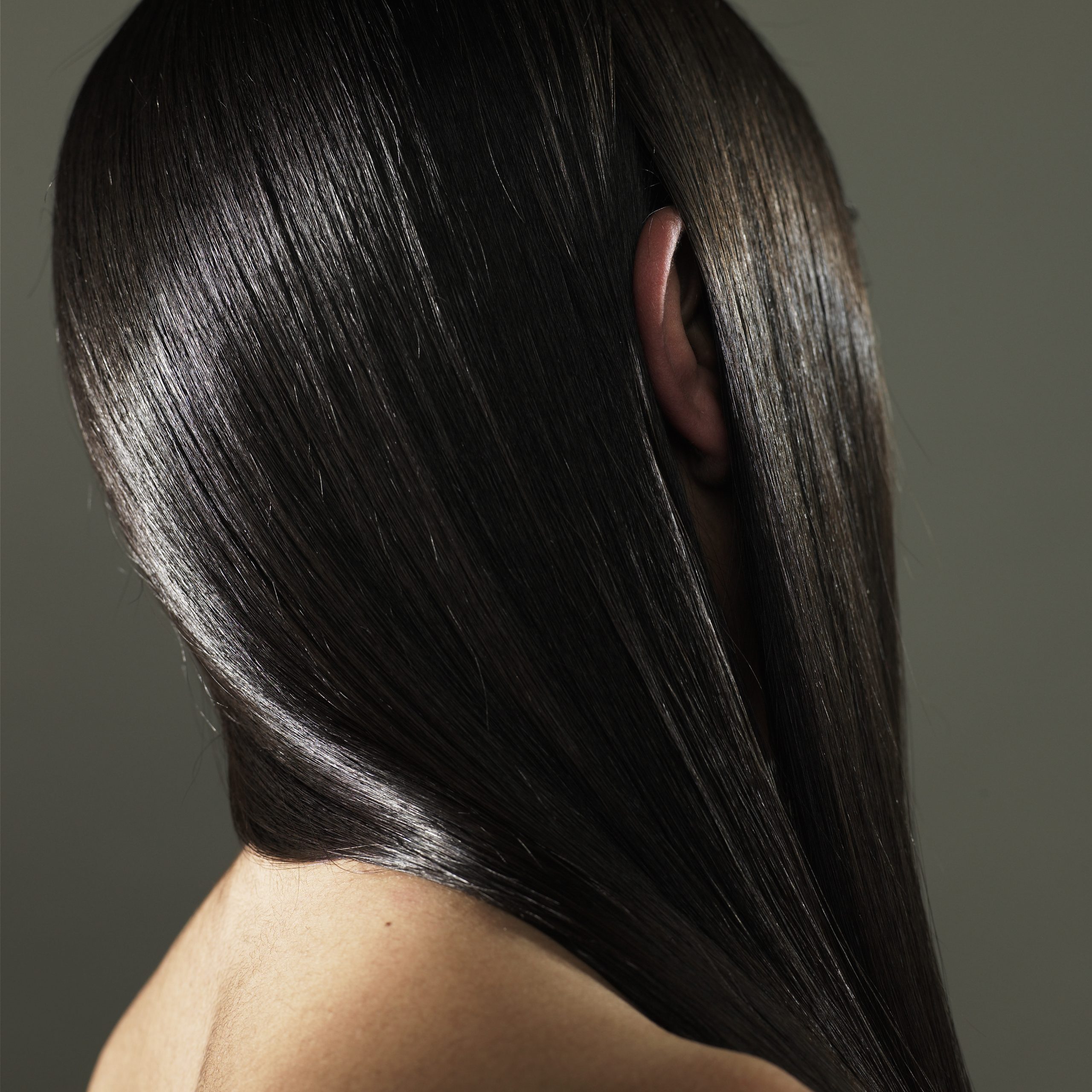 Young woman with ear sticking out of long hair, side view Young woman with ear sticking out of long hair, side view